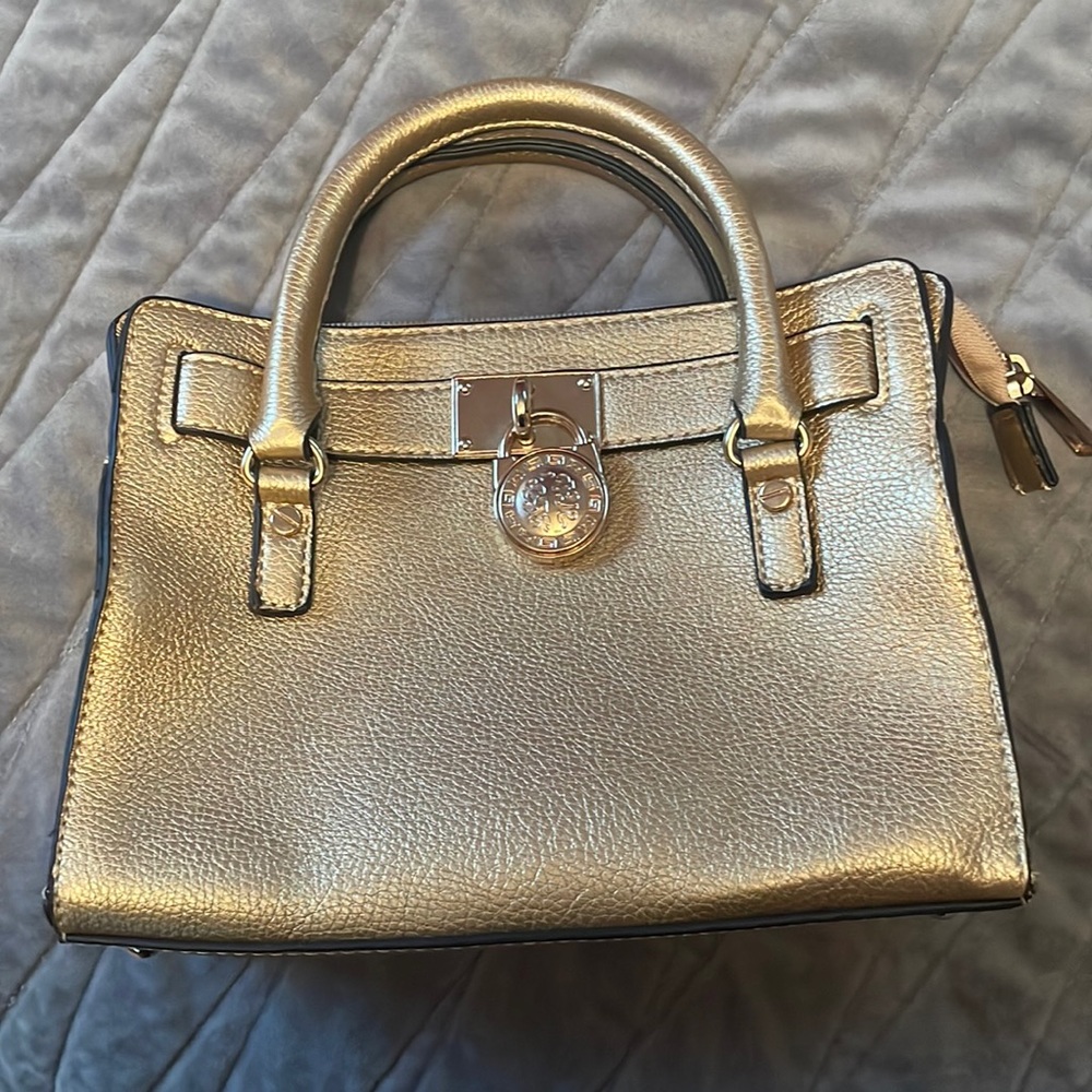 2 gold handbags one satchel w/ shoulder strap and one envelope.